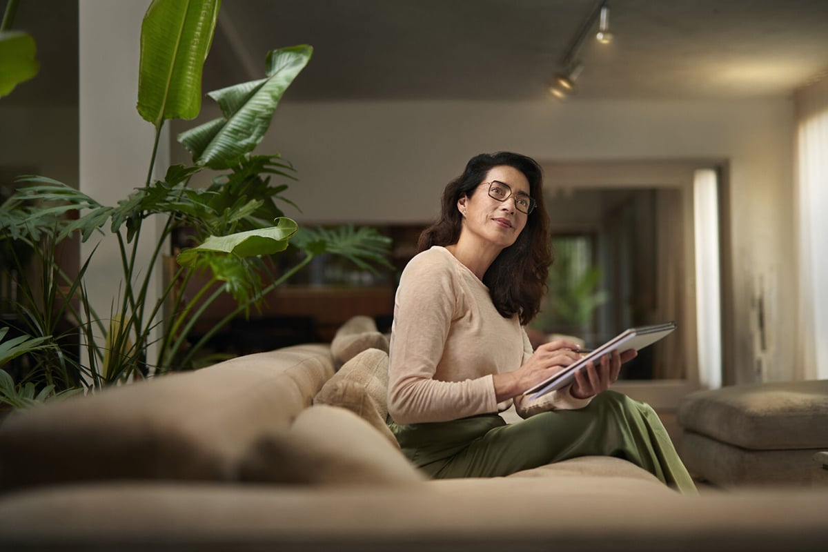 Woman wearing glasses holding notebook
