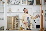 Male painting whilst wearing glasses 