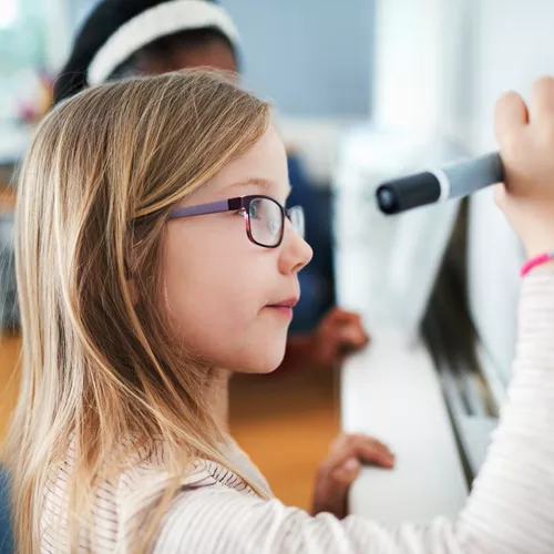 Image of children wearing classes within a classroom 