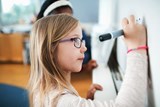 Image of children wearing classes within a classroom 