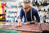 Landscape image of male whilst working with fabric 