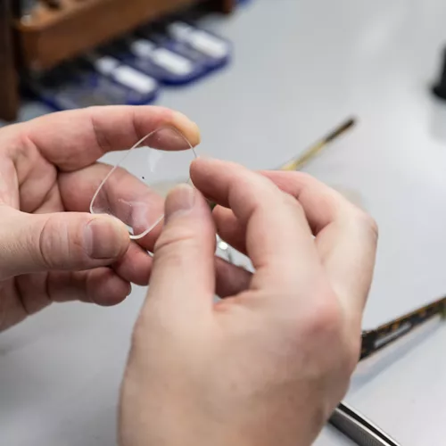 Image of an optician examining a lens