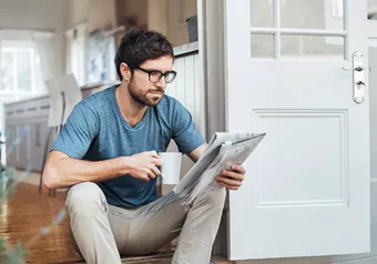 Man with occupational lenses reading newspaper