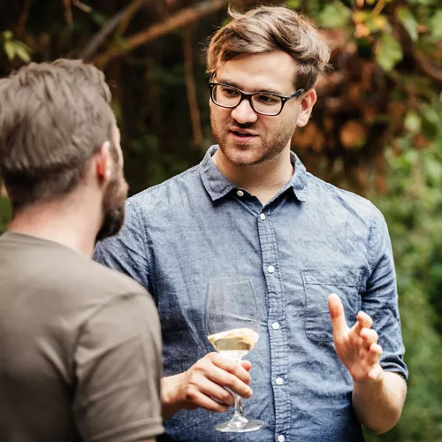Young man wearing glasses having a conversation with a friend