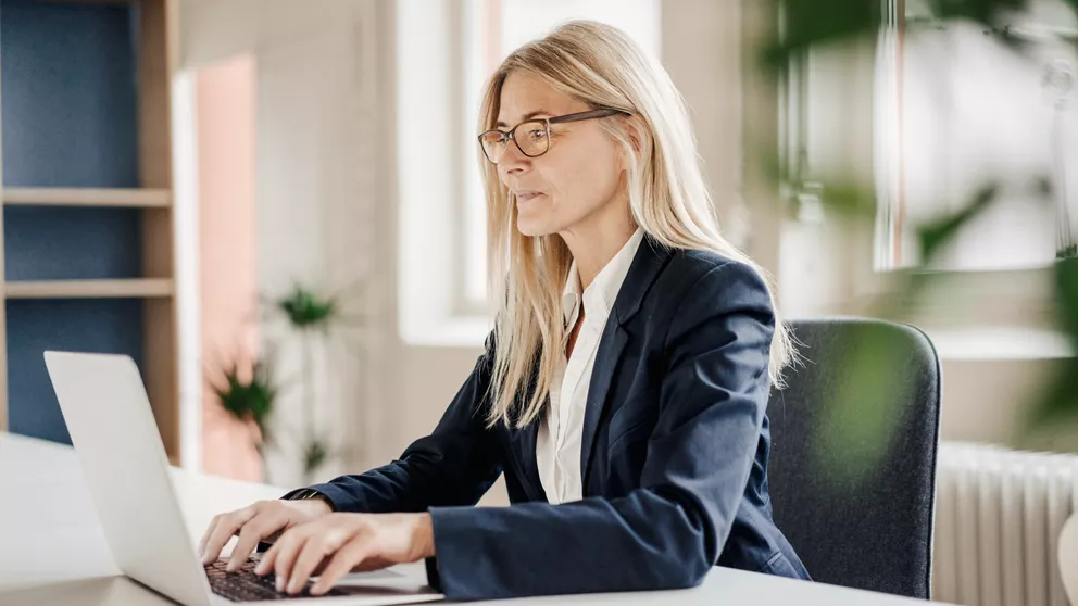 Woman working on a laptop with occupational glasses