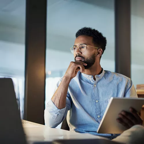 Man with blue shirt wearing occupational lenses while looking at screens