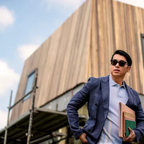 Business man in a sharp suit wearing sunglasses outdoors