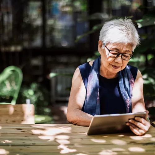 Older lady with glasses looking at tablet