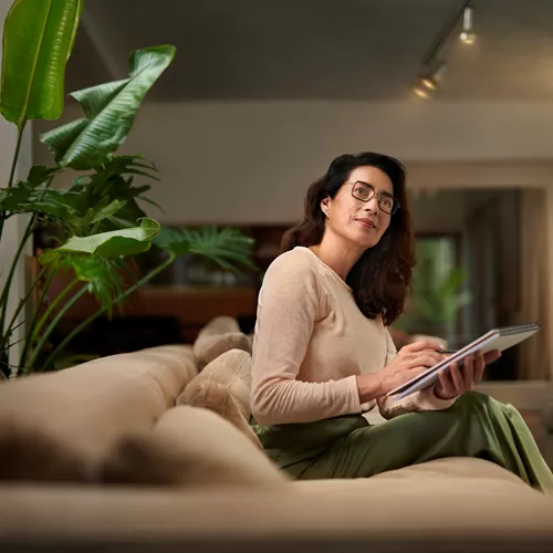 Woman with glasses holding a notepad