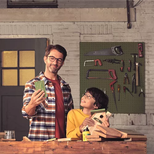 Man and son DIY-ing while both wearing HOYA Sensity 2 lenses