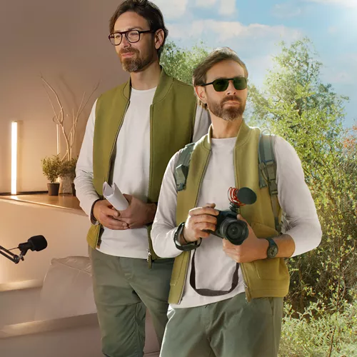 Photographer in green vest wearing HOYA Sensity Dark photochromic lenses during work