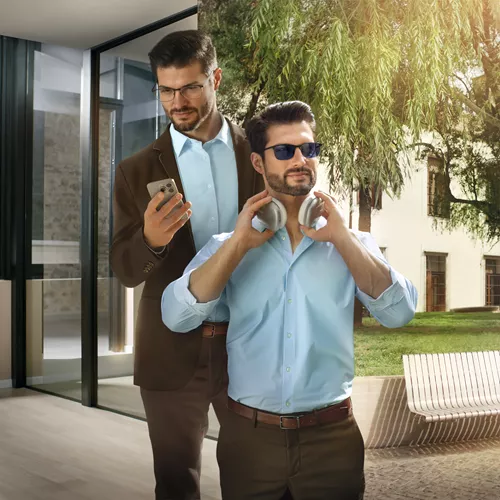 Business man wearing HOYA Sensity 2 light reactive lenses both indoors and outdoors