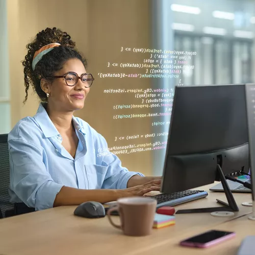Woman wearing HOYA VisuPro glasses working on a computer with sharp vision