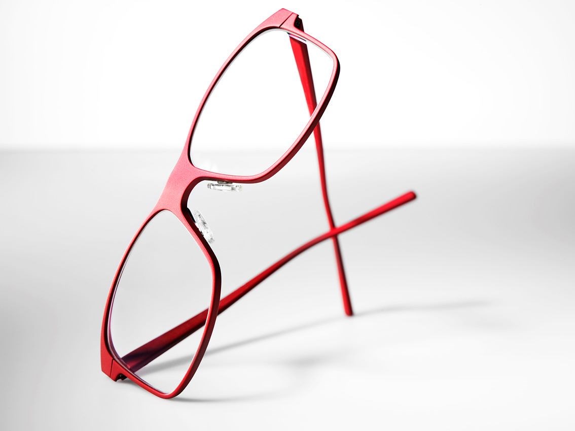 Pair of red lightweight eyeglasses with Hoya Vision digital lenses