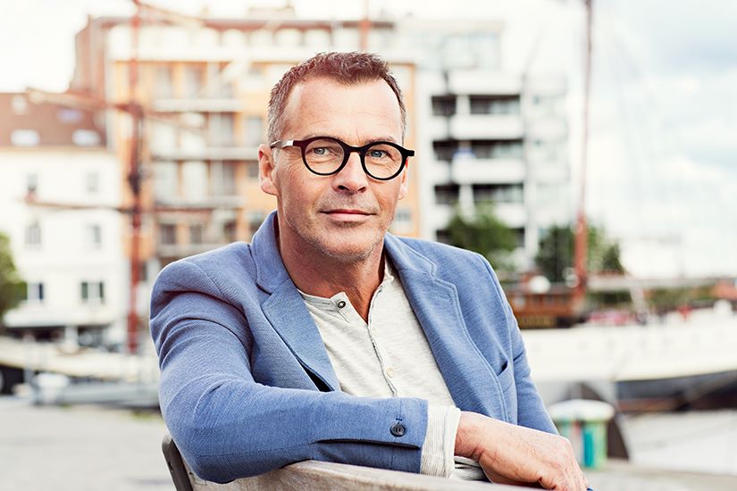 Hoya Vision core values trust man in blue blazer on bench