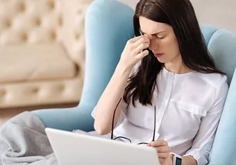 Female suffering from a headache due to digital eyestrain