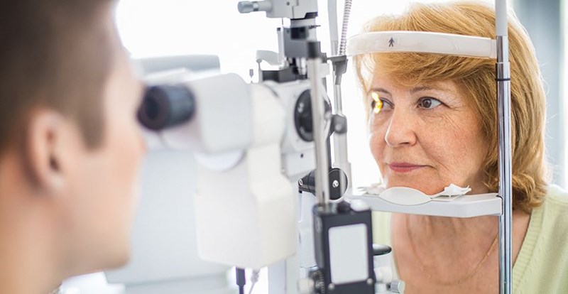 Older woman getting an eye examination by a Hoya Vision optician