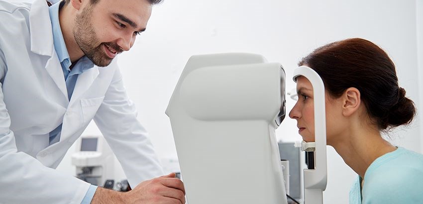 Woman getting an eye scan by a male Hoya Vision optician