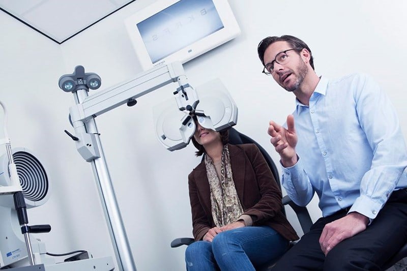 Woman getting having an eye test by a male Hoya Vision optician