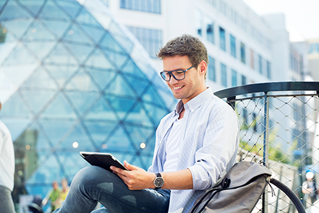Man wearing Hoya Single Vision digital lenses reading from tablet