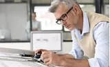 Male architect drawing indoors wearing Hoya Vision indoor lenses 