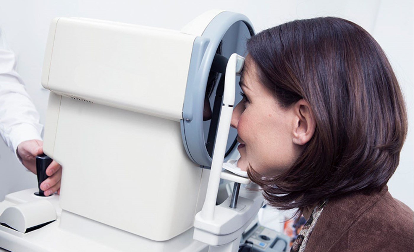 Female using an eye scanner operated by a male Hoya Vision optician