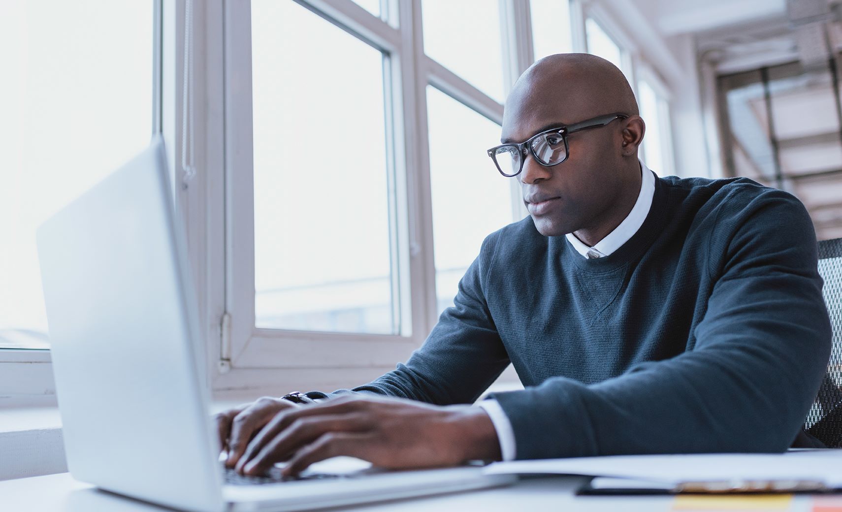 Hoya Vision special lenses man in front of computer