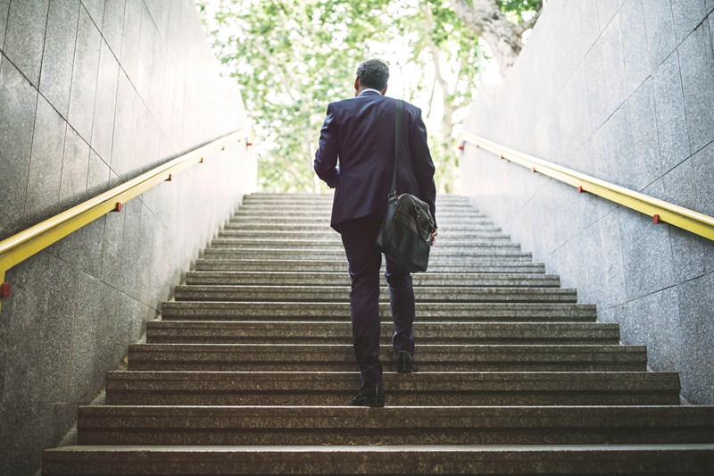 Business man walking up stairs