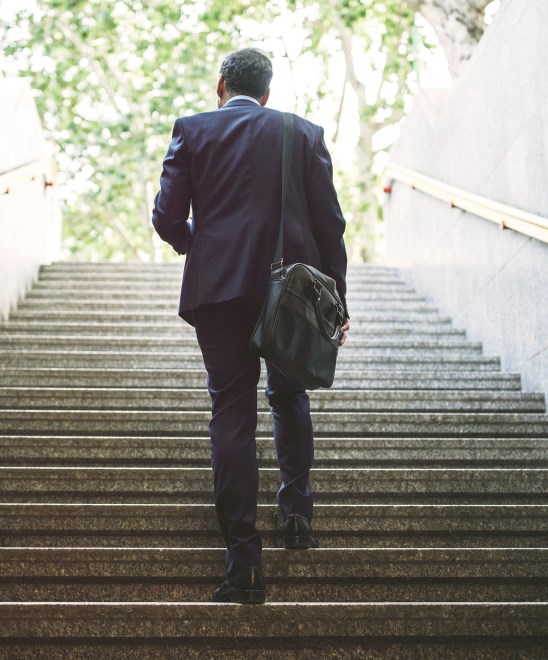 Businessman walking up a flight of stairs