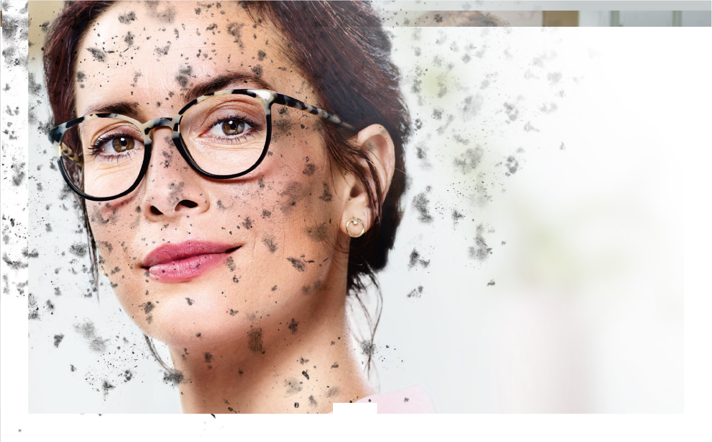 Woman wearing eyeglasses with Hoya Vision lenses behind a dirty screen