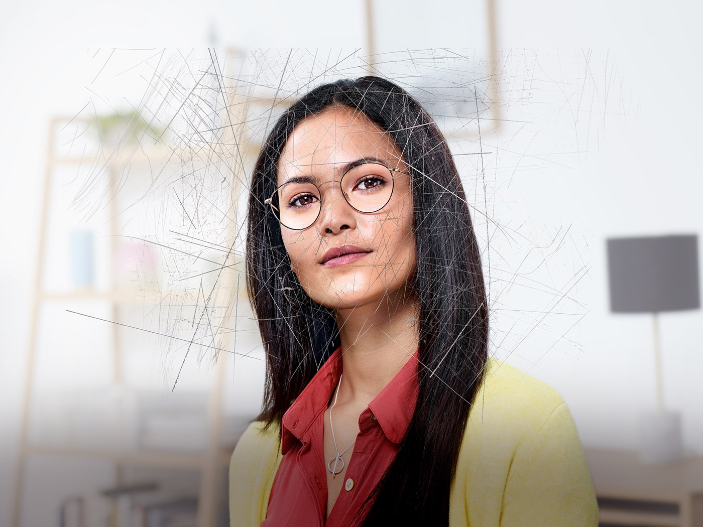 Woman wearing eyeglasses with Hoya Vision lenses behind a scratched screen