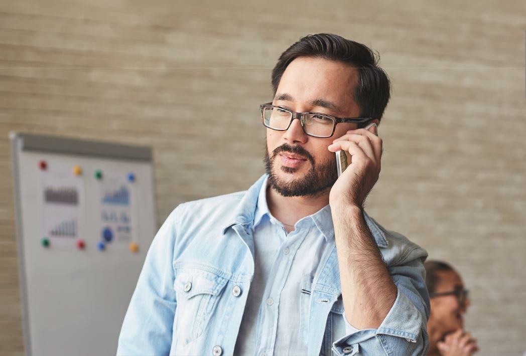 Male wearing eyeglass frames on mobile phone call
