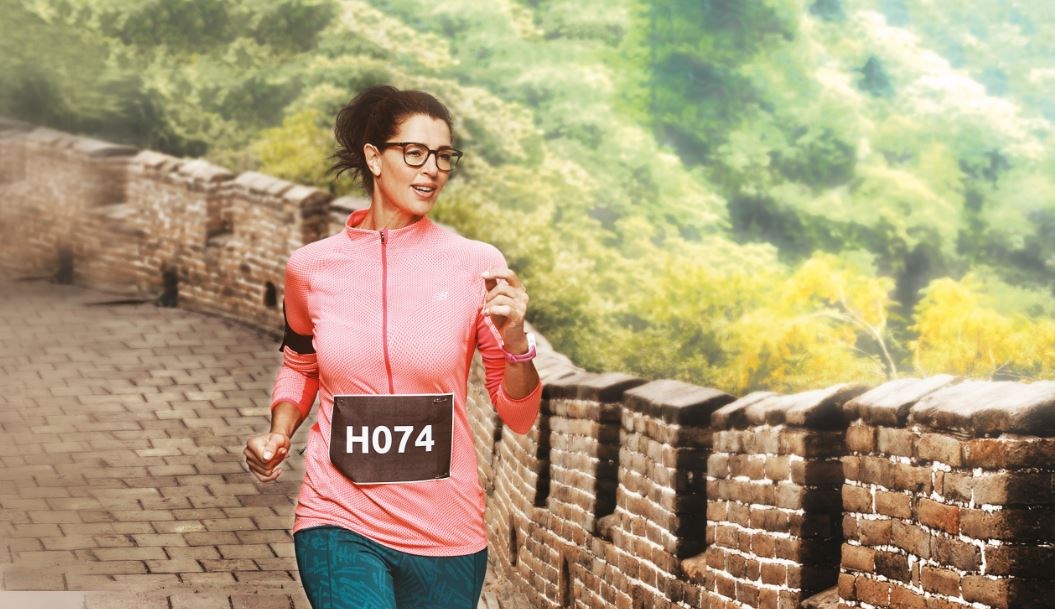 Female runner in pink top outside wearing eyeglass frames