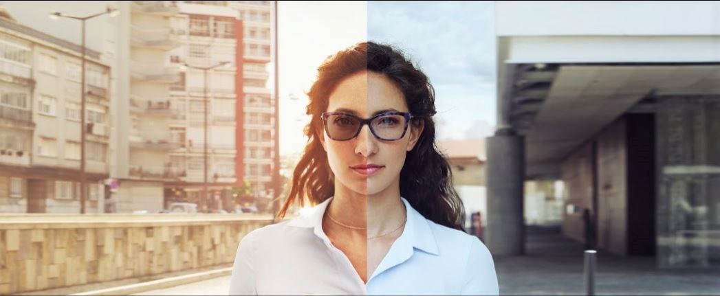 Female wearing eyeglasses with sunglass lenses on one side and clear vision lenses on other side
