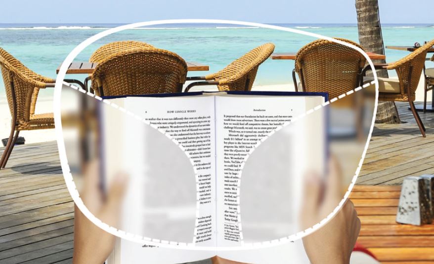 Image of book being read through slightly blurred lenses