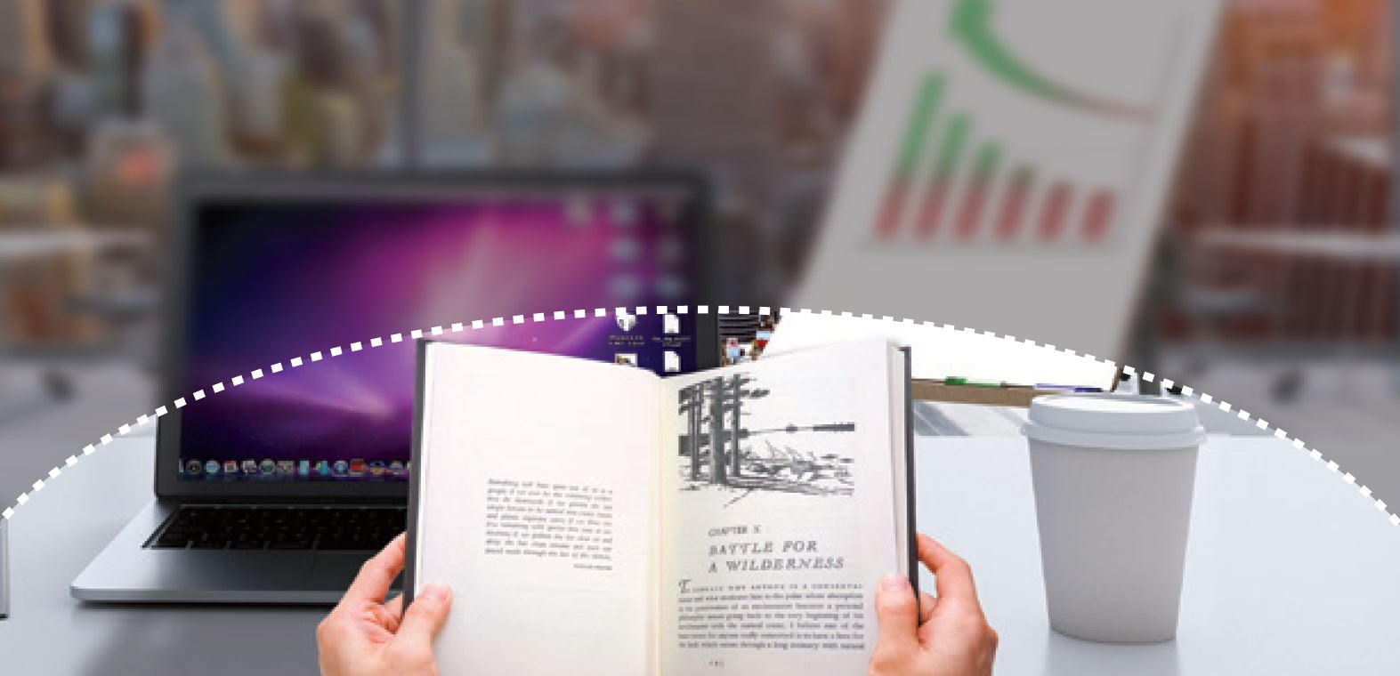 Unclear view of desk with book, laptop and coffee cup