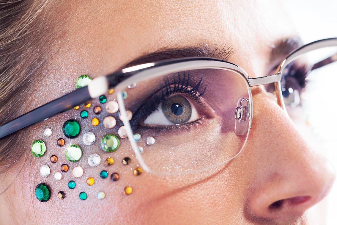 Woman wearing eyeglasses with jewels on her face