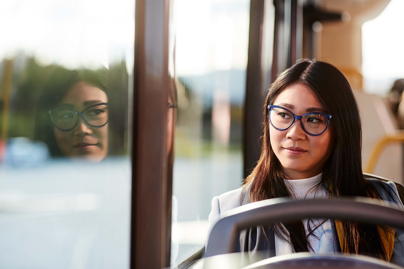 Woman on public transport wearing photochromic lenses