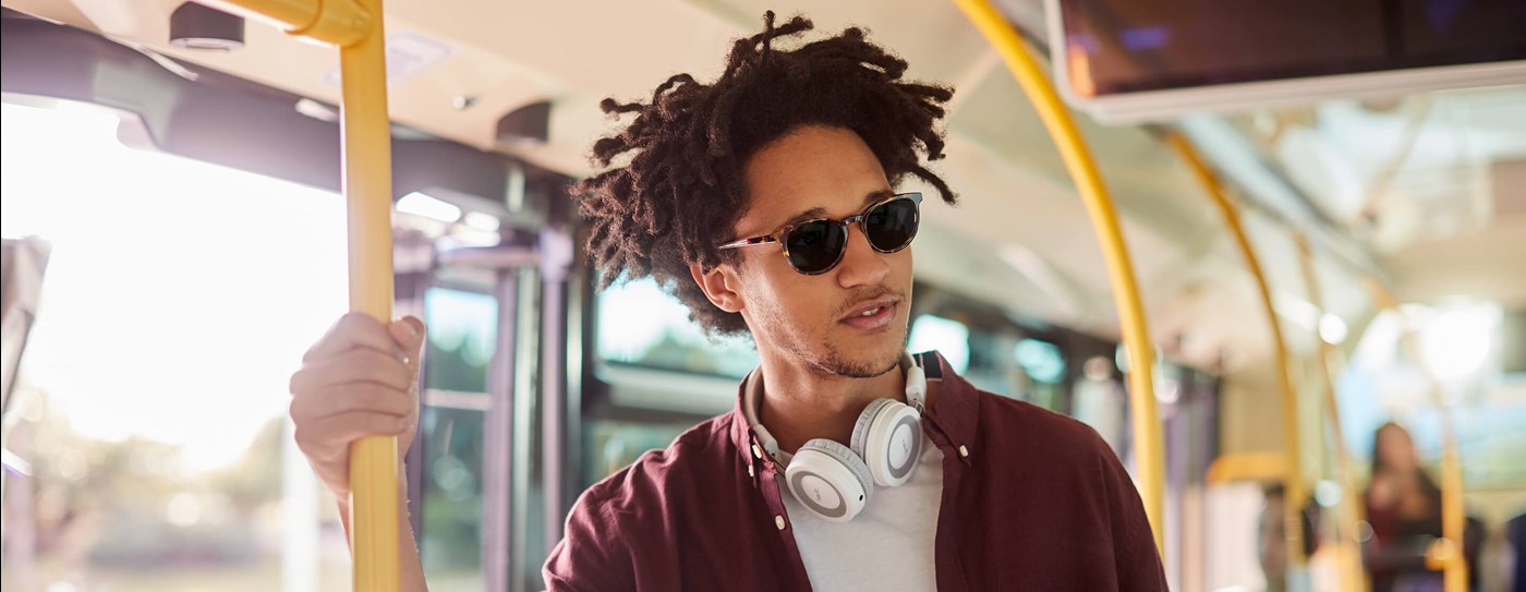 Male on public transport wearing photochromic lenses