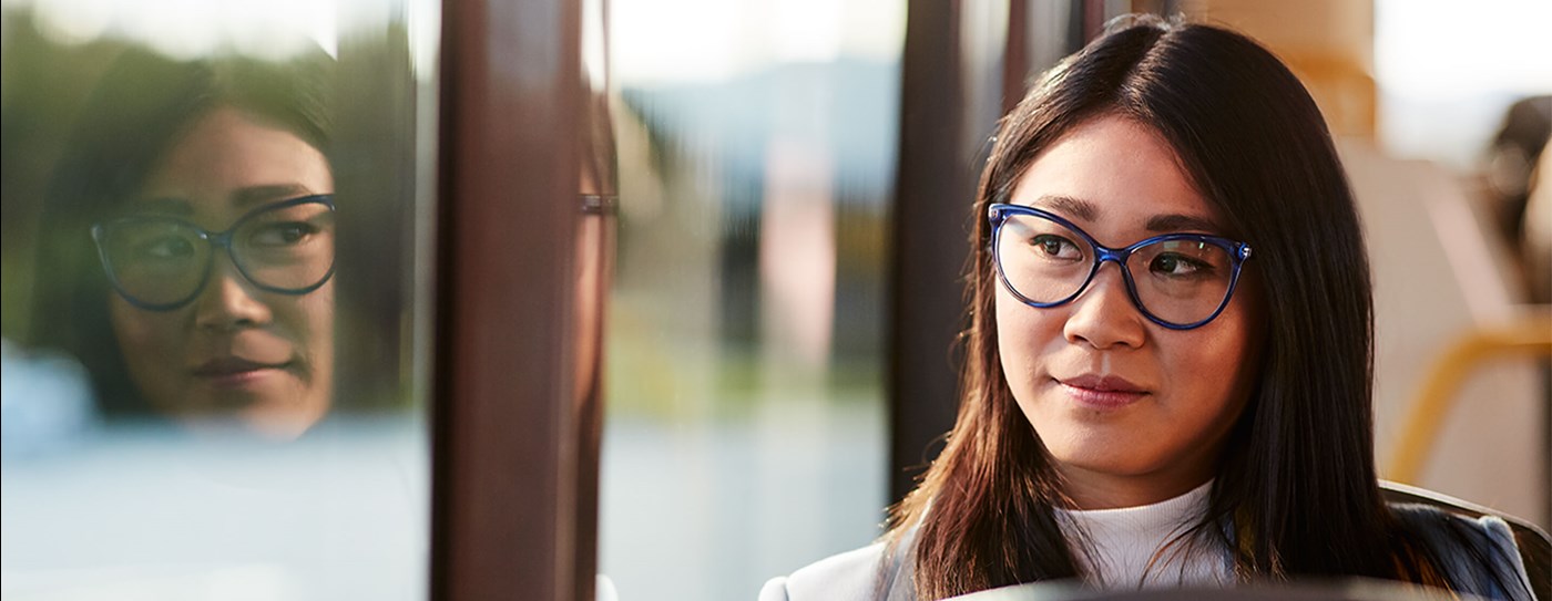 Woman on public transport wearing photochromic lenses